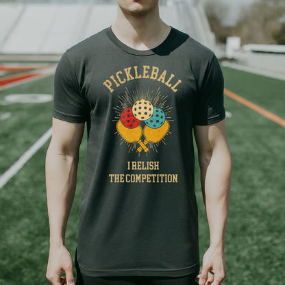 a man wearing a pickleball t - shirt on a field