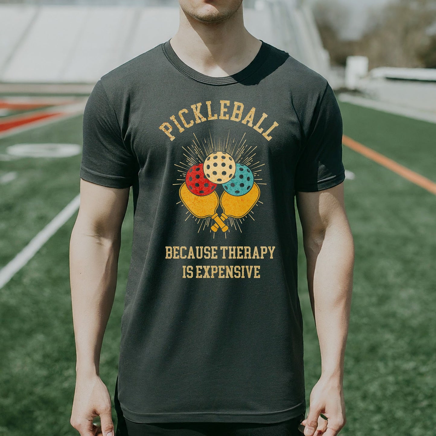 a man standing on a field wearing a t - shirt