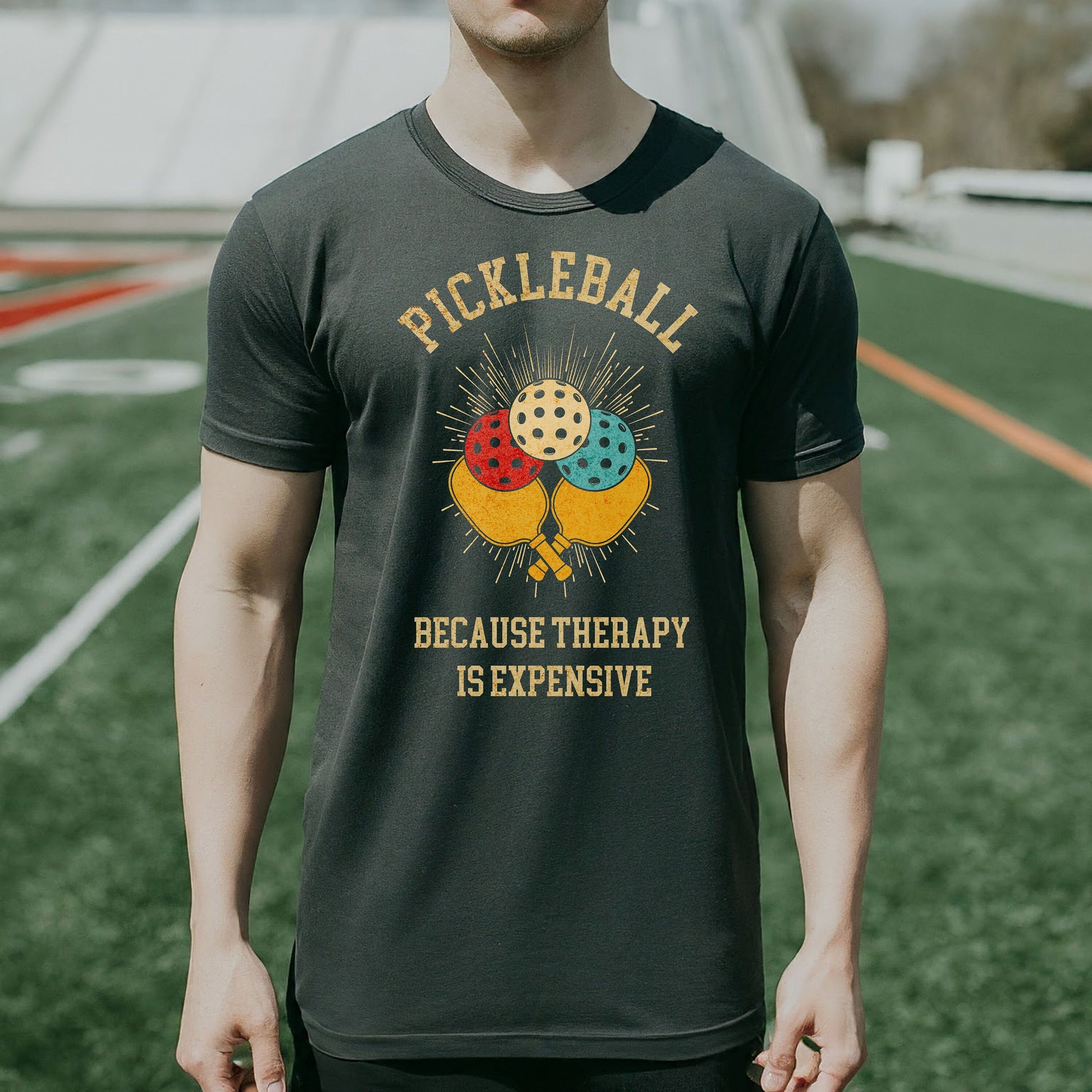 a man standing on a field wearing a t - shirt