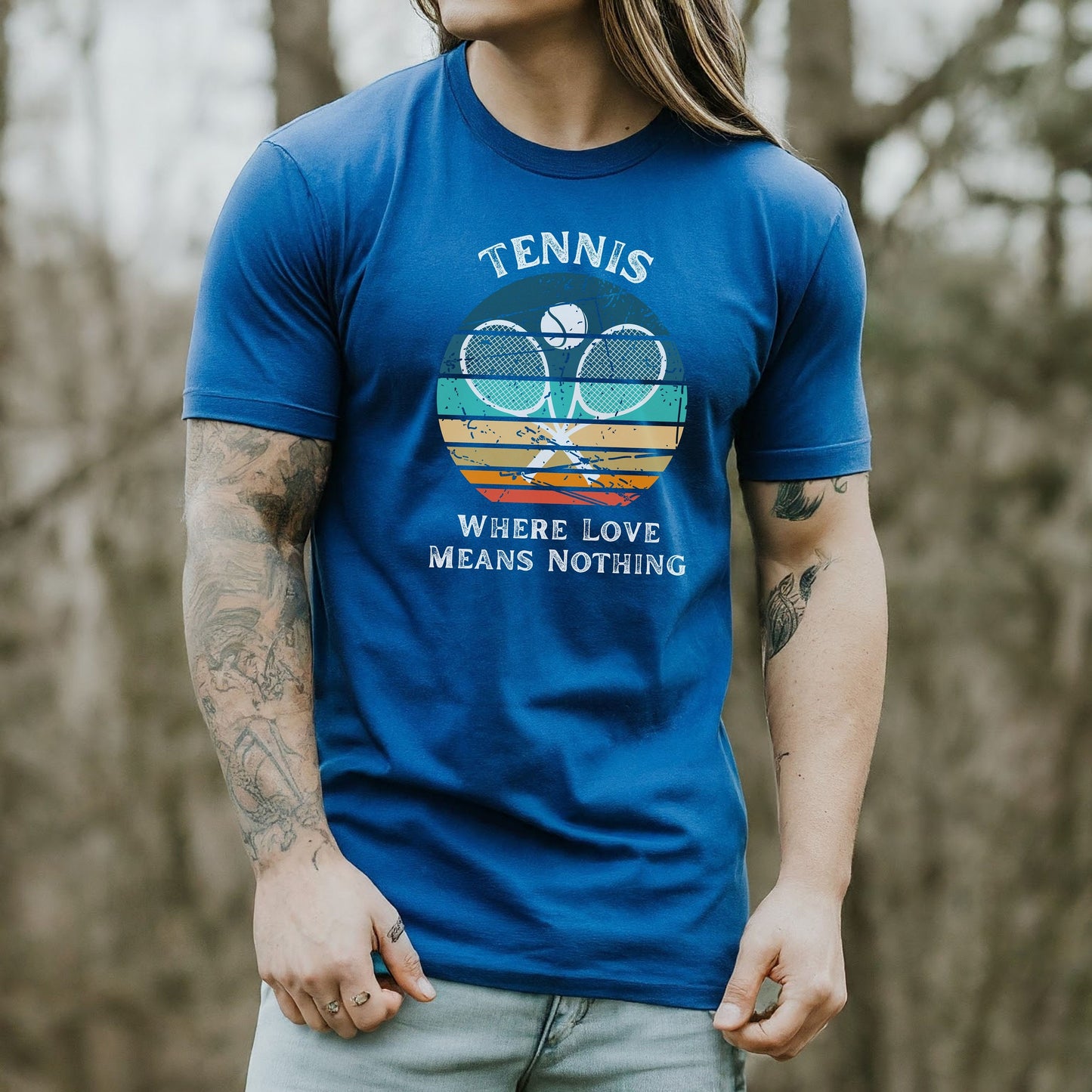 a man with long hair wearing a blue tennis shirt