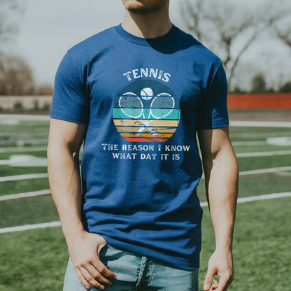a man standing on a field wearing a tennis shirt