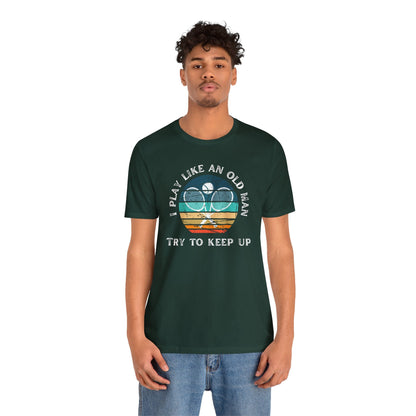 a man wearing a t - shirt that says play like an old man try to