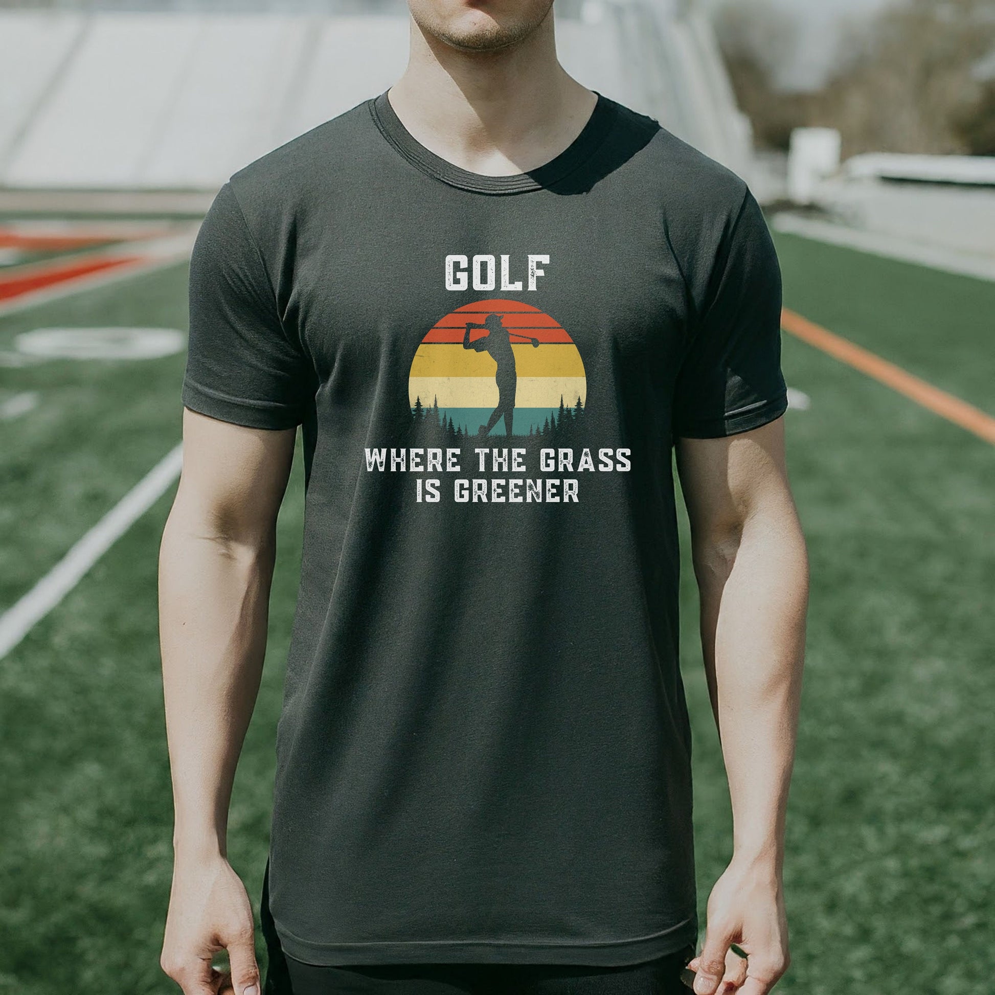 a man standing on a field wearing a golf shirt
