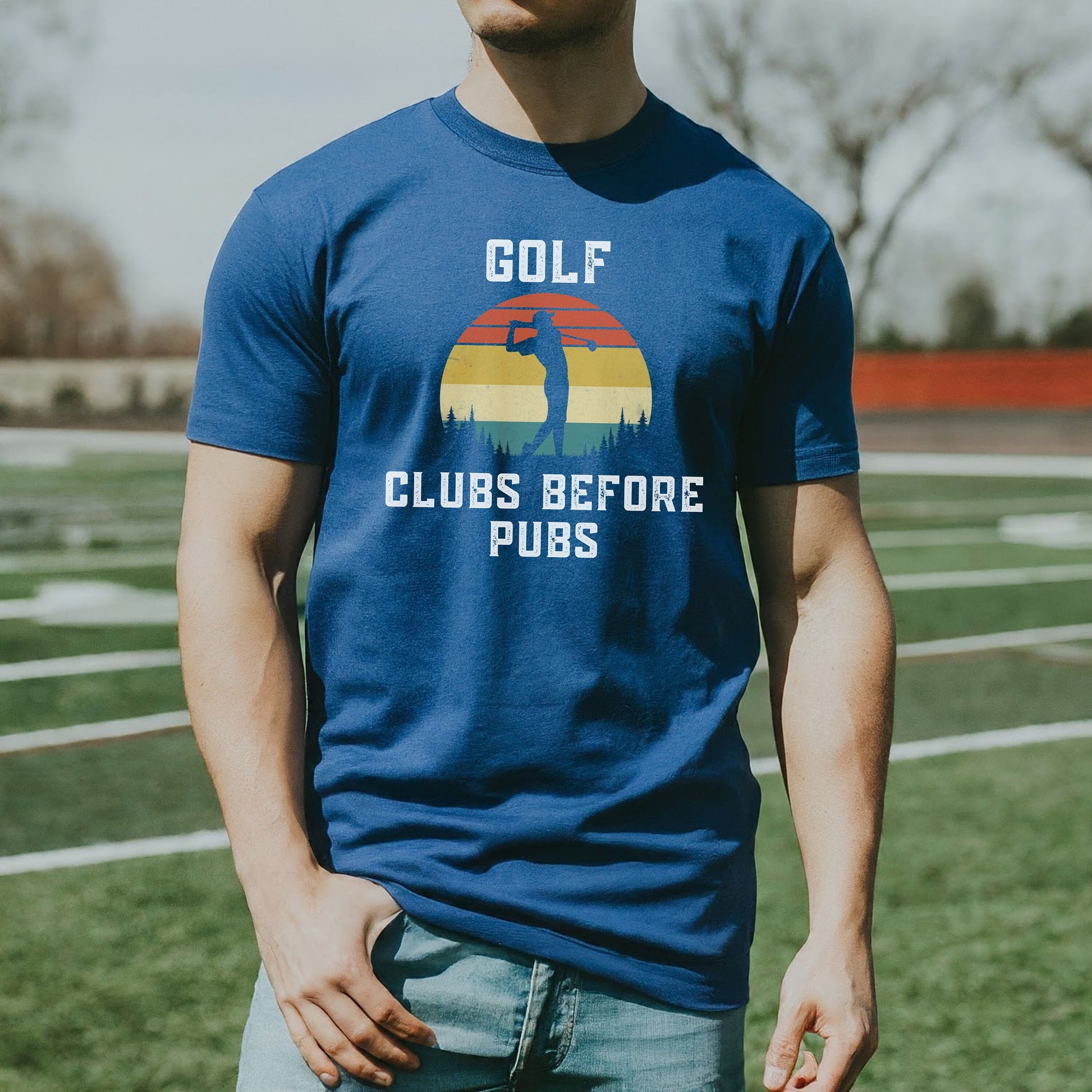 a man standing on a field wearing a blue shirt