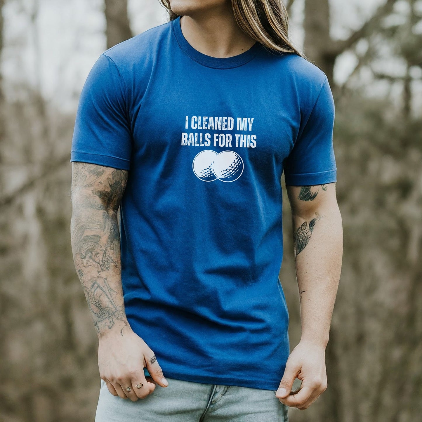 a man with long hair wearing a blue shirt