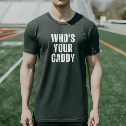 a man standing on a field wearing a t - shirt that says who's