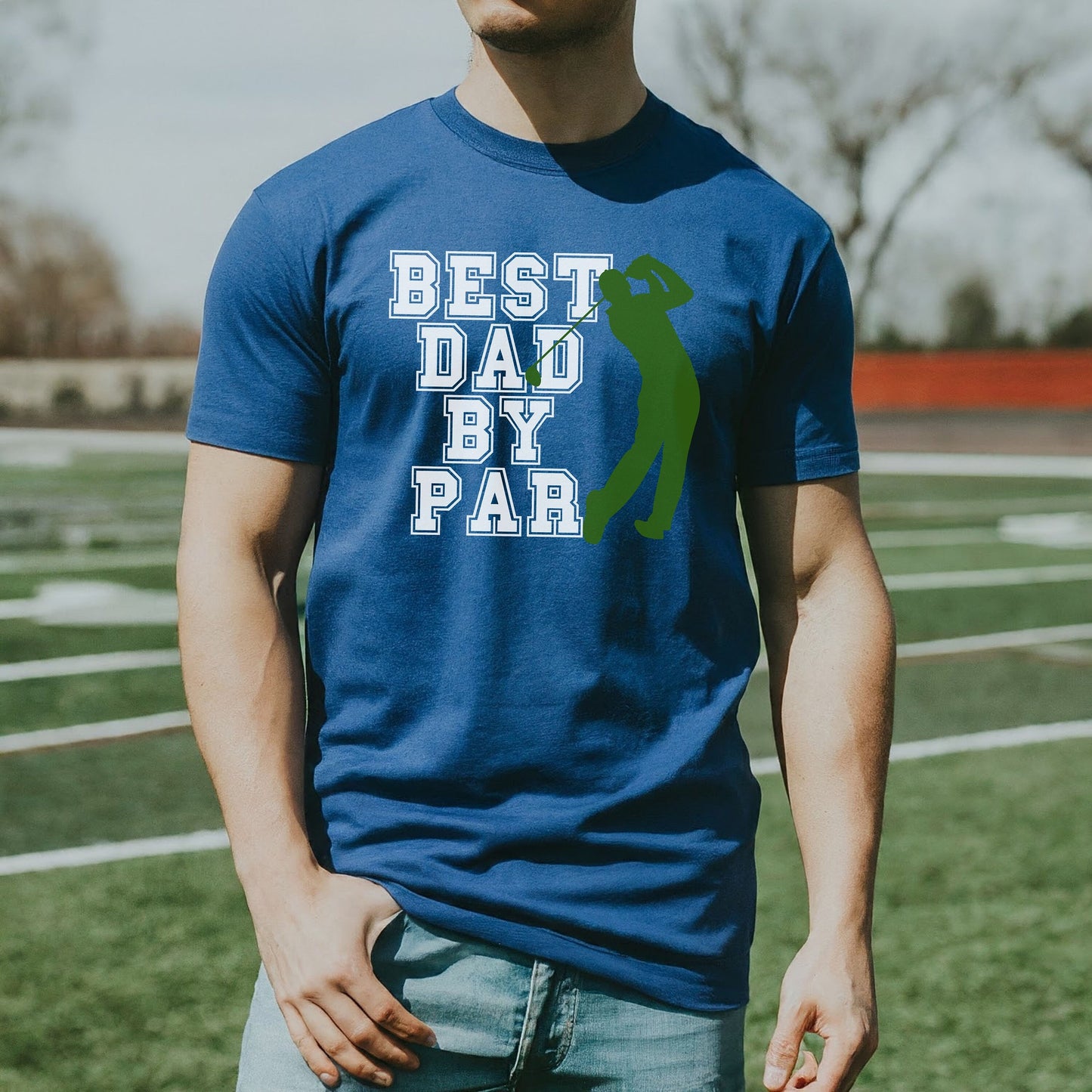 a man standing on a field wearing a t - shirt that says best dad by