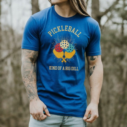a man wearing a pickleball kind of a big dilll t - shirt