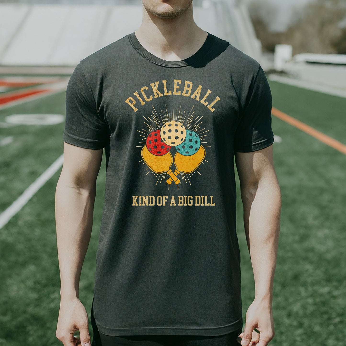 a man wearing a pickleball kind of a big dilll t - shirt
