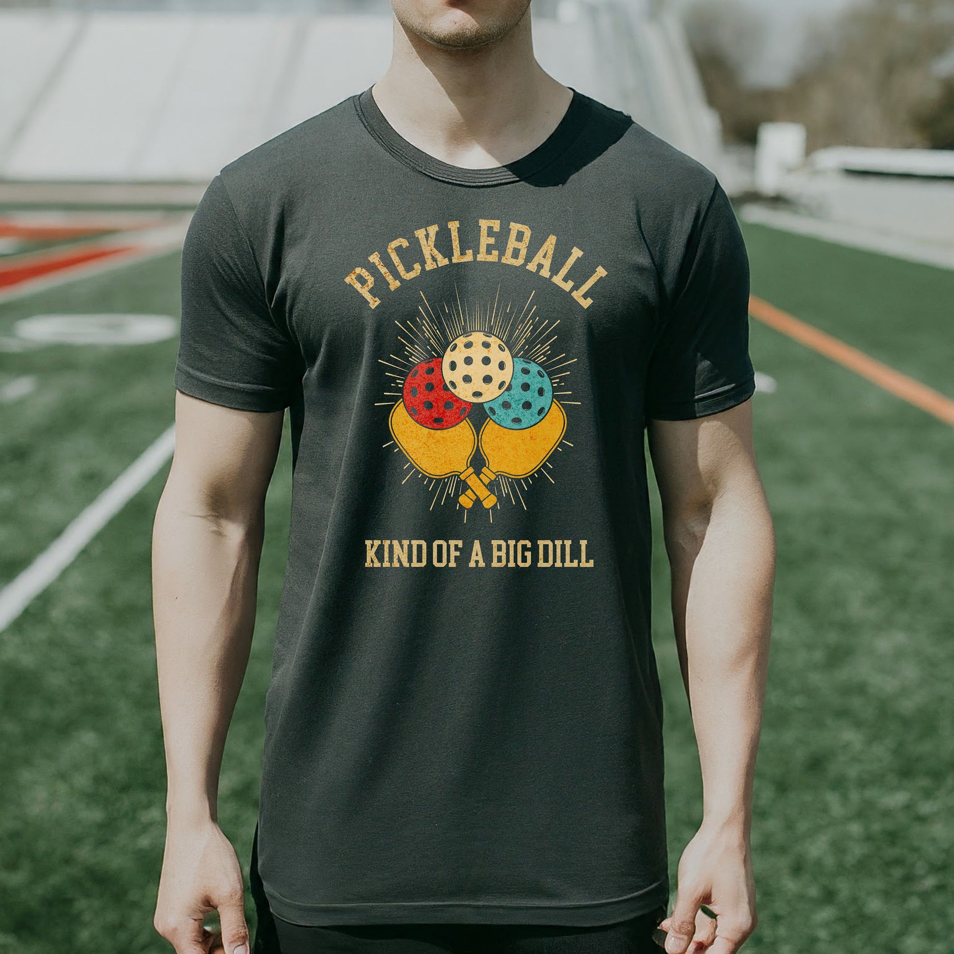 a man wearing a pickleball kind of a big dilll t - shirt