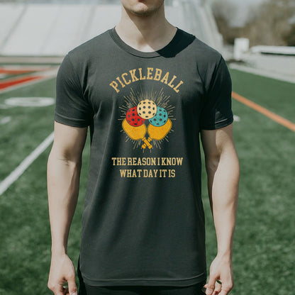 a man wearing a pickleball t - shirt on a field