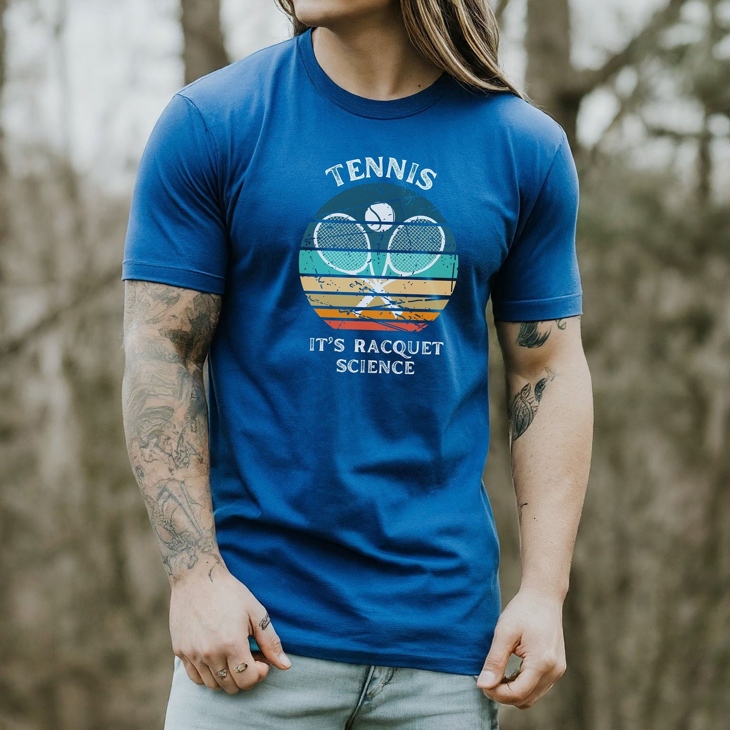 a man with long hair wearing a tennis racket t - shirt