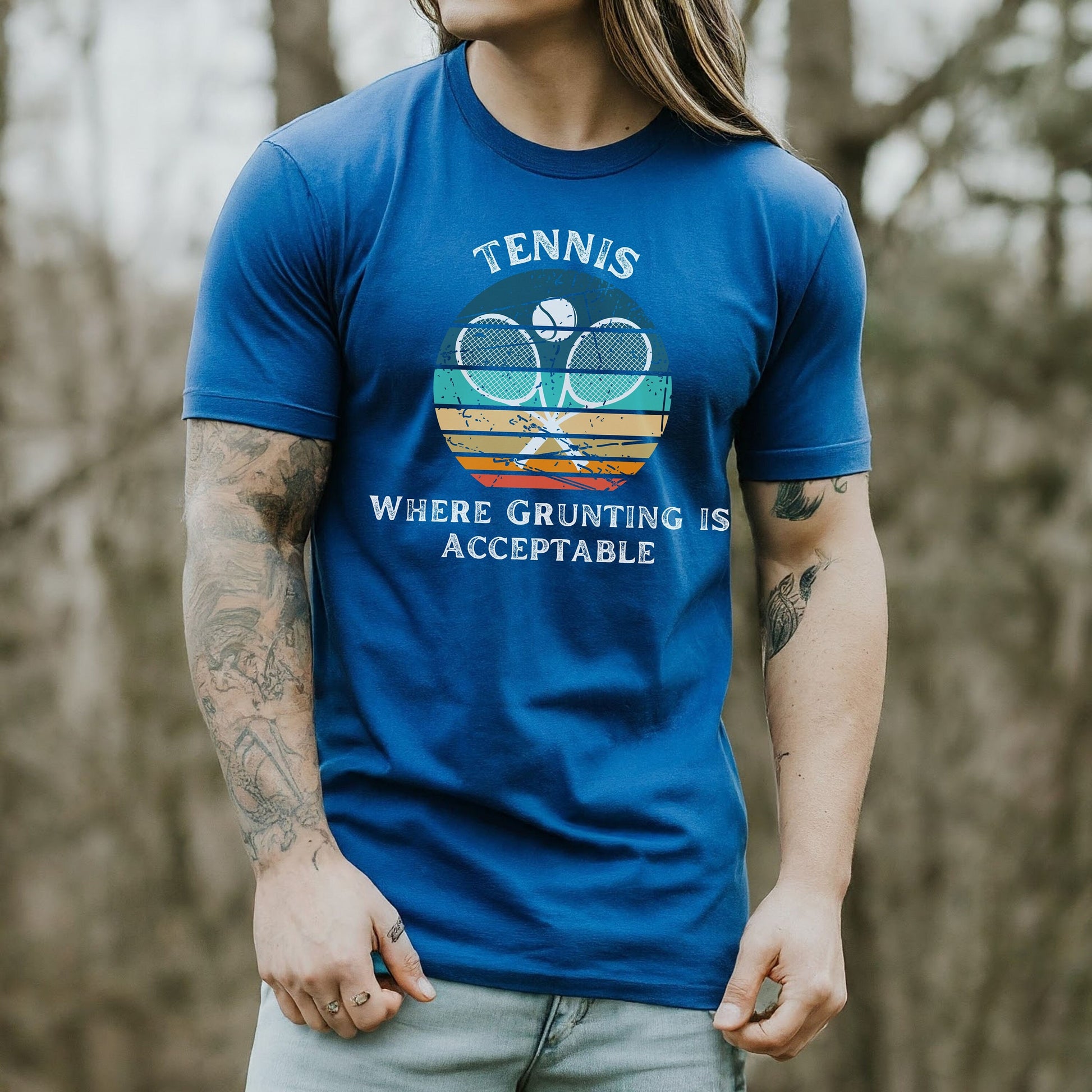 a man with long hair wearing a blue tennis shirt