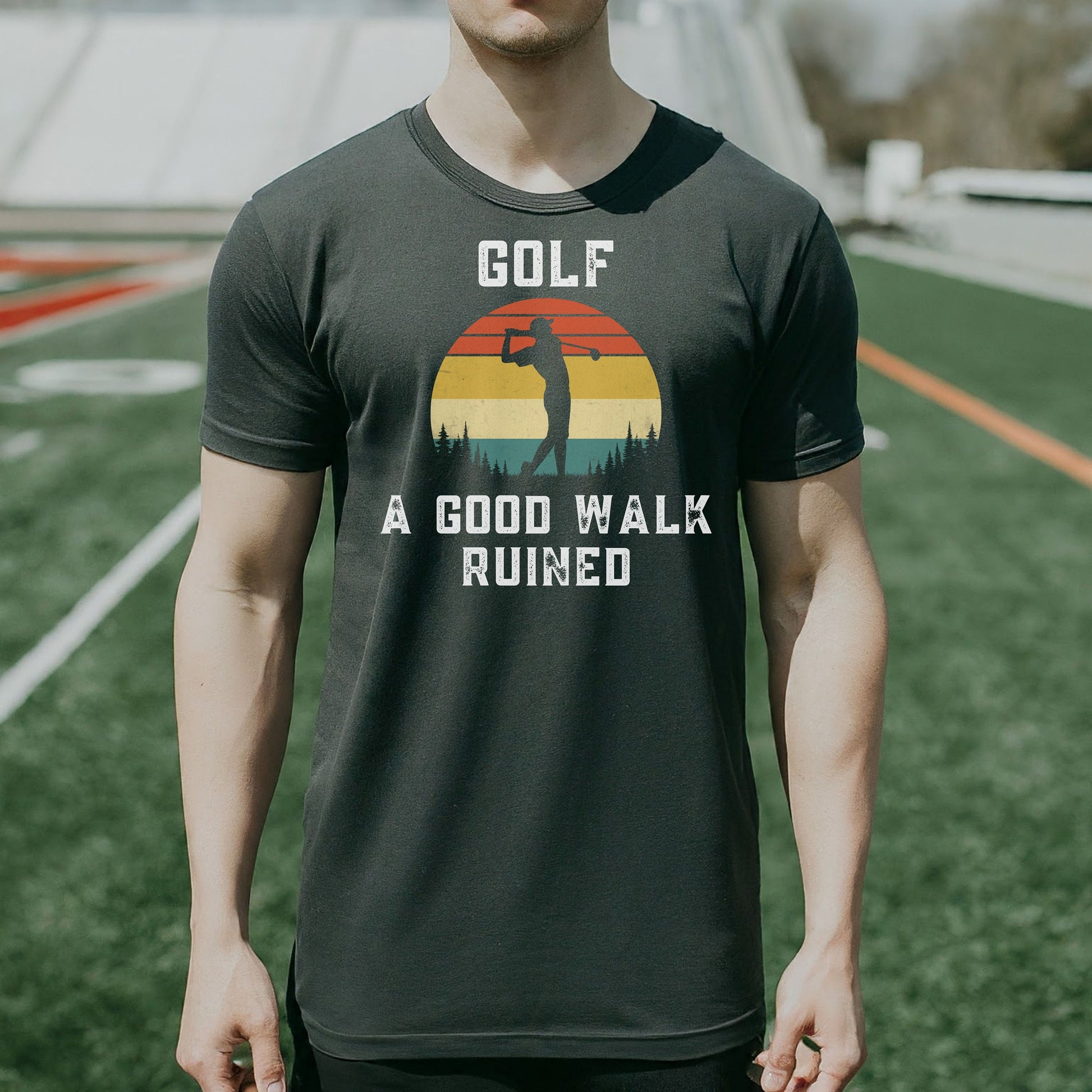 a man standing on a field wearing a golf shirt