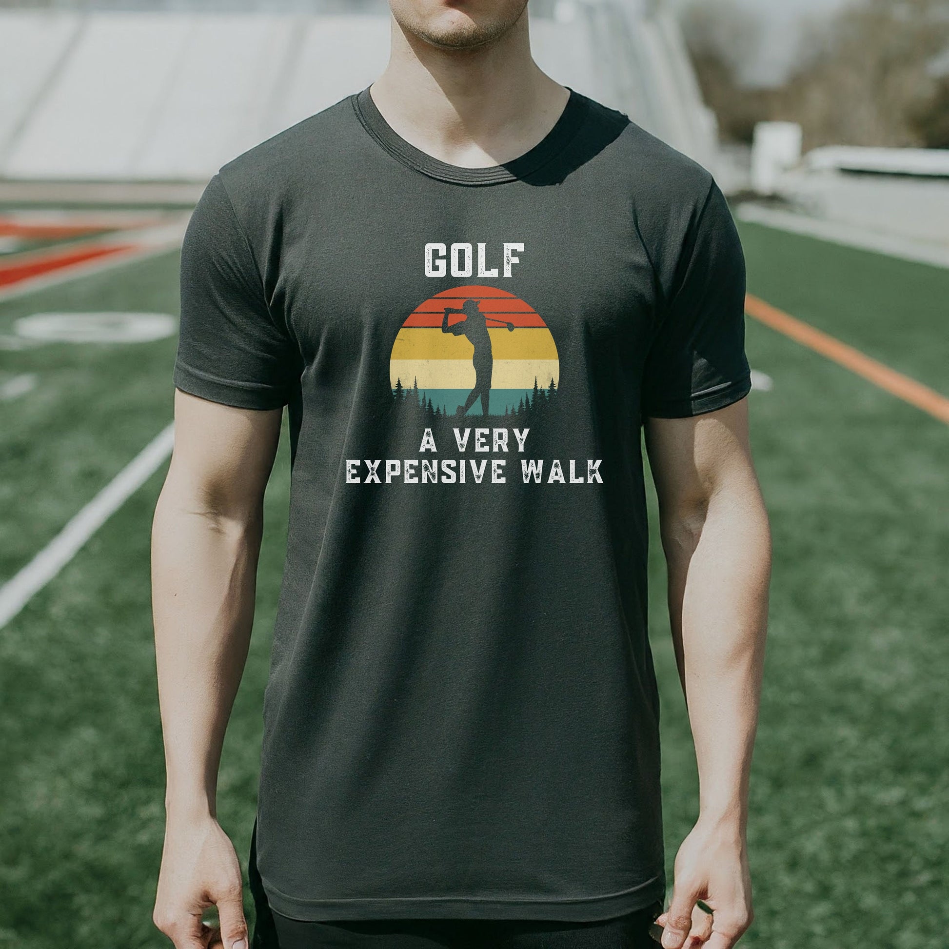 a man standing on a field wearing a golf shirt