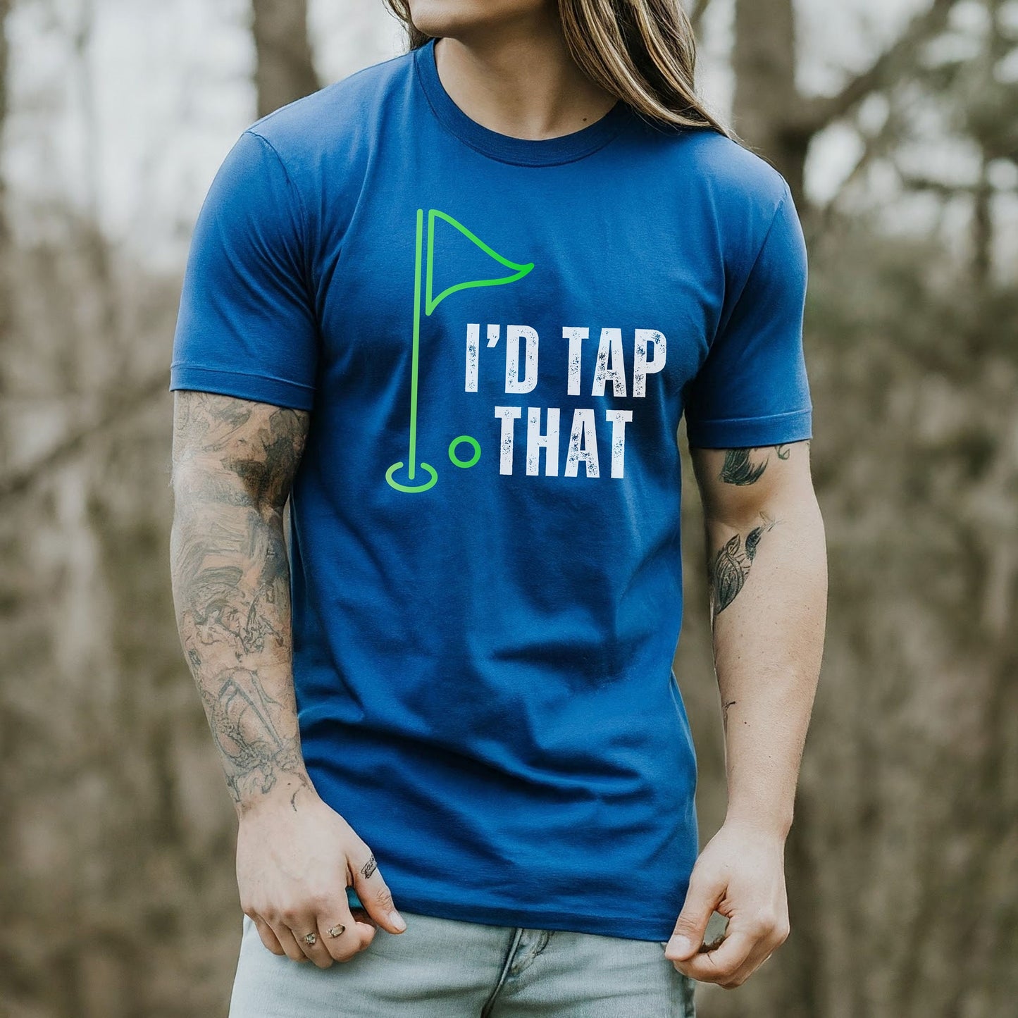 a man with long hair wearing a blue t - shirt that says i'd