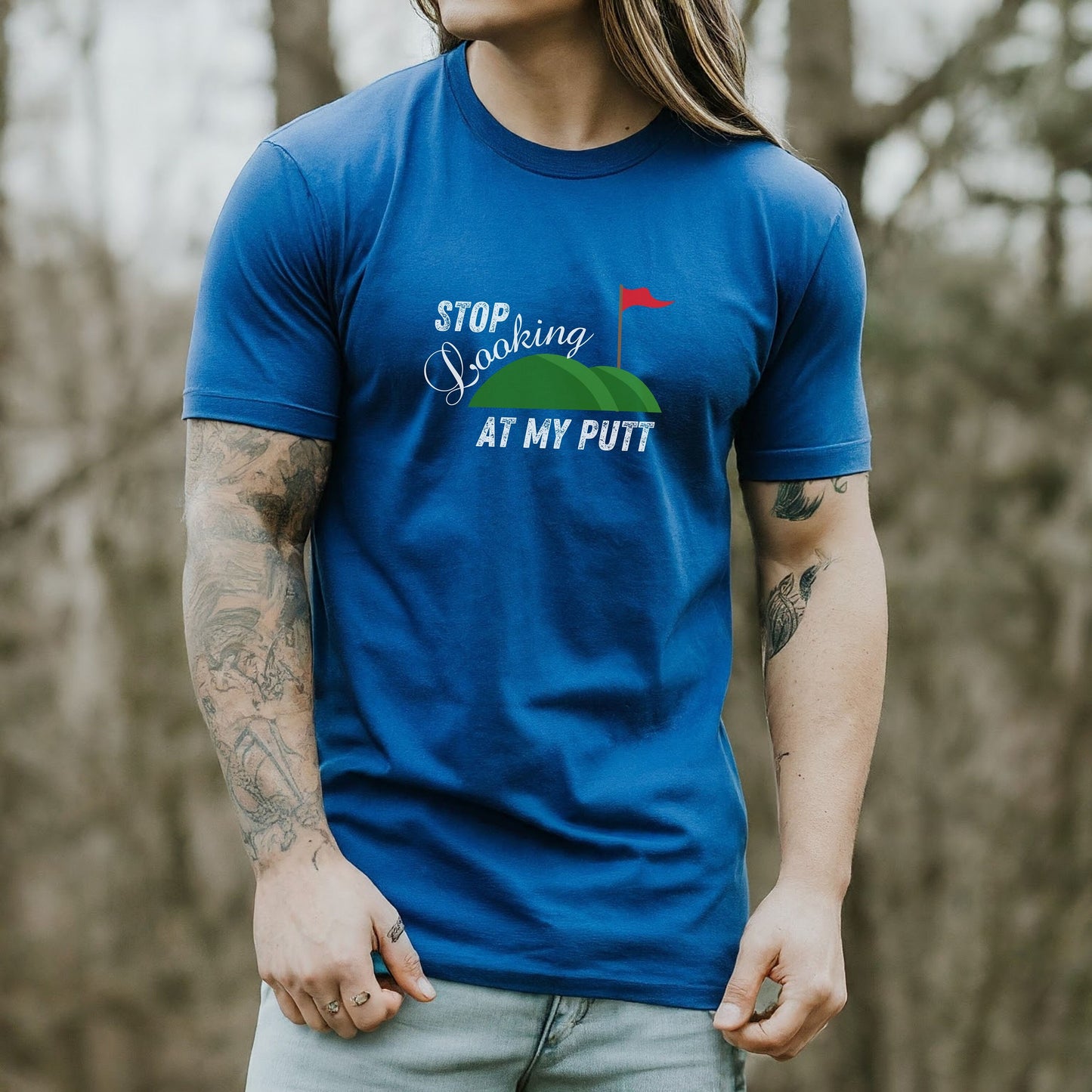 a man with long hair wearing a blue shirt