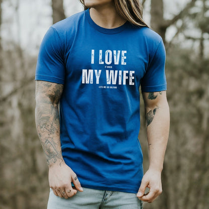 a man with long hair wearing a t - shirt that says i love my wife