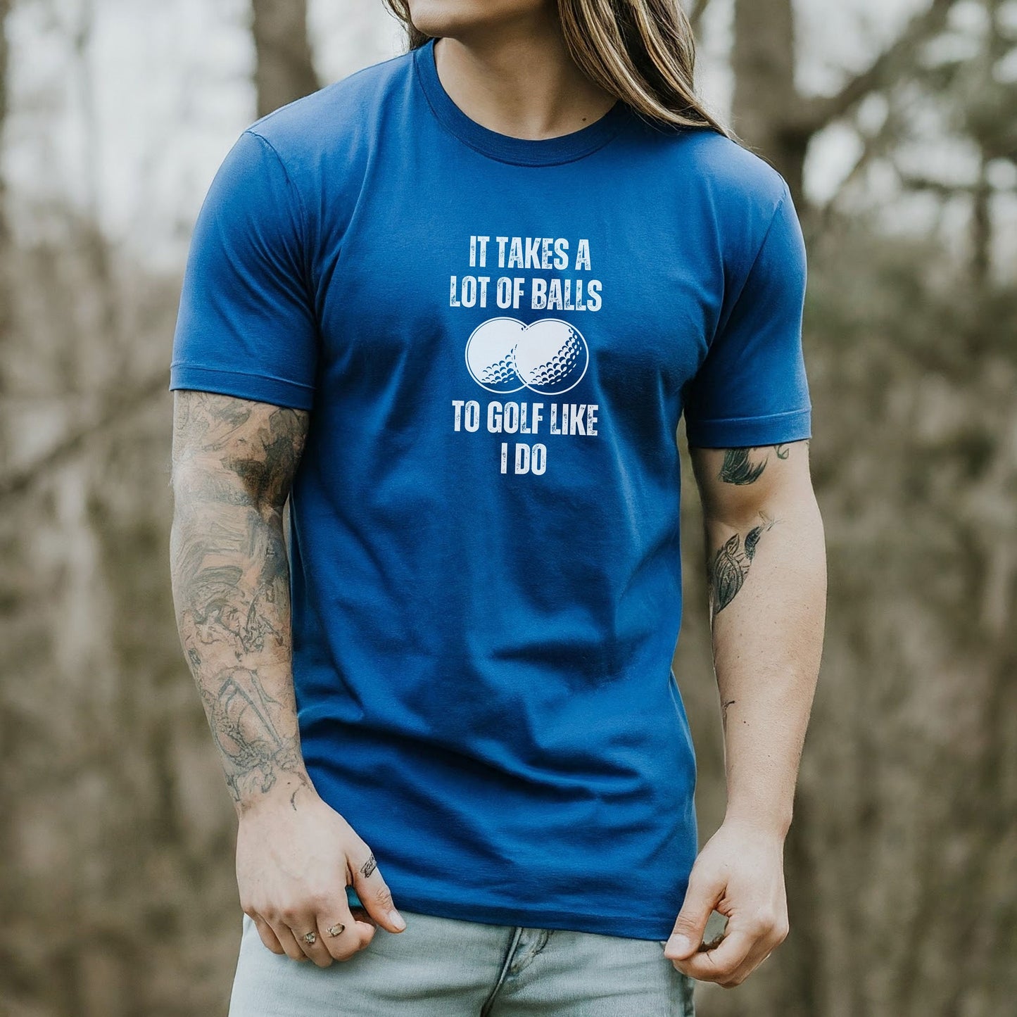 a man with long hair wearing a blue shirt