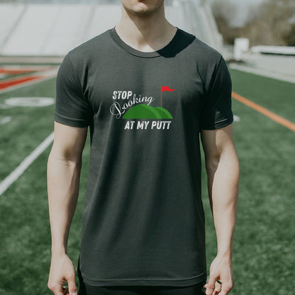 a man standing on top of a field wearing a black shirt