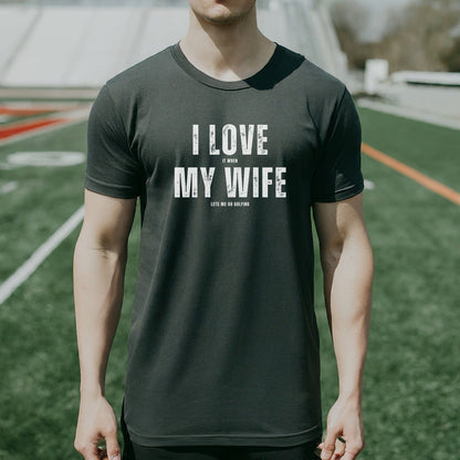 a man standing on a field wearing a t - shirt that says i love my