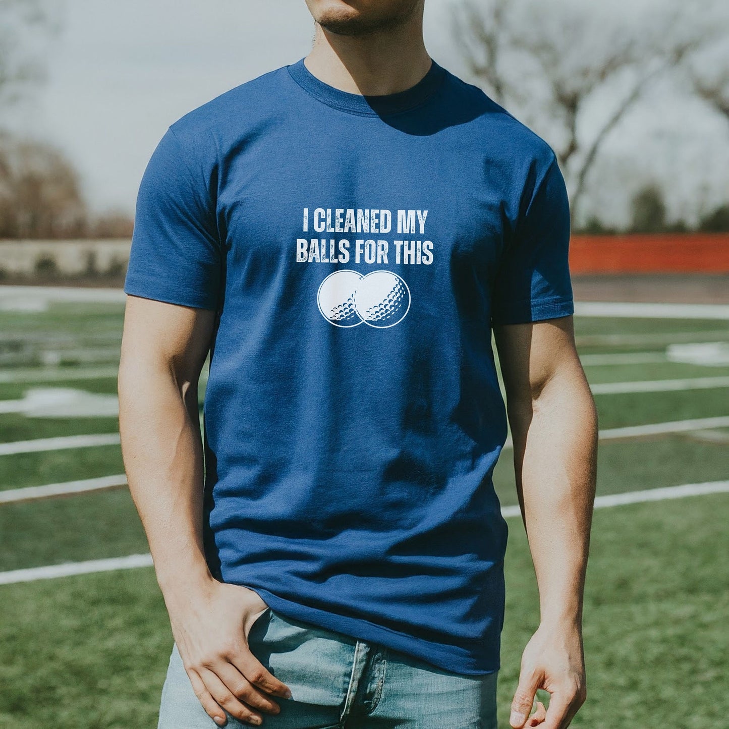 a man standing on a field wearing a t - shirt that says i cleaned my