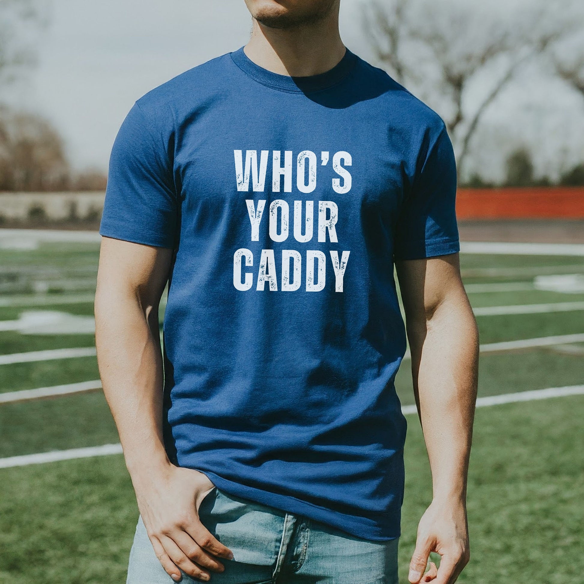 a man in a blue t - shirt that says who's your caddy