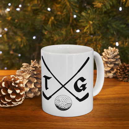 a white coffee mug with a golf club and ball on it