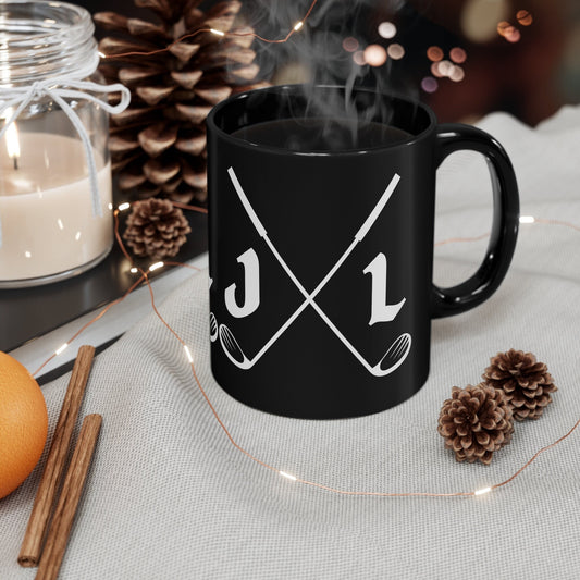 a black coffee mug with two crossed golf clubs on it