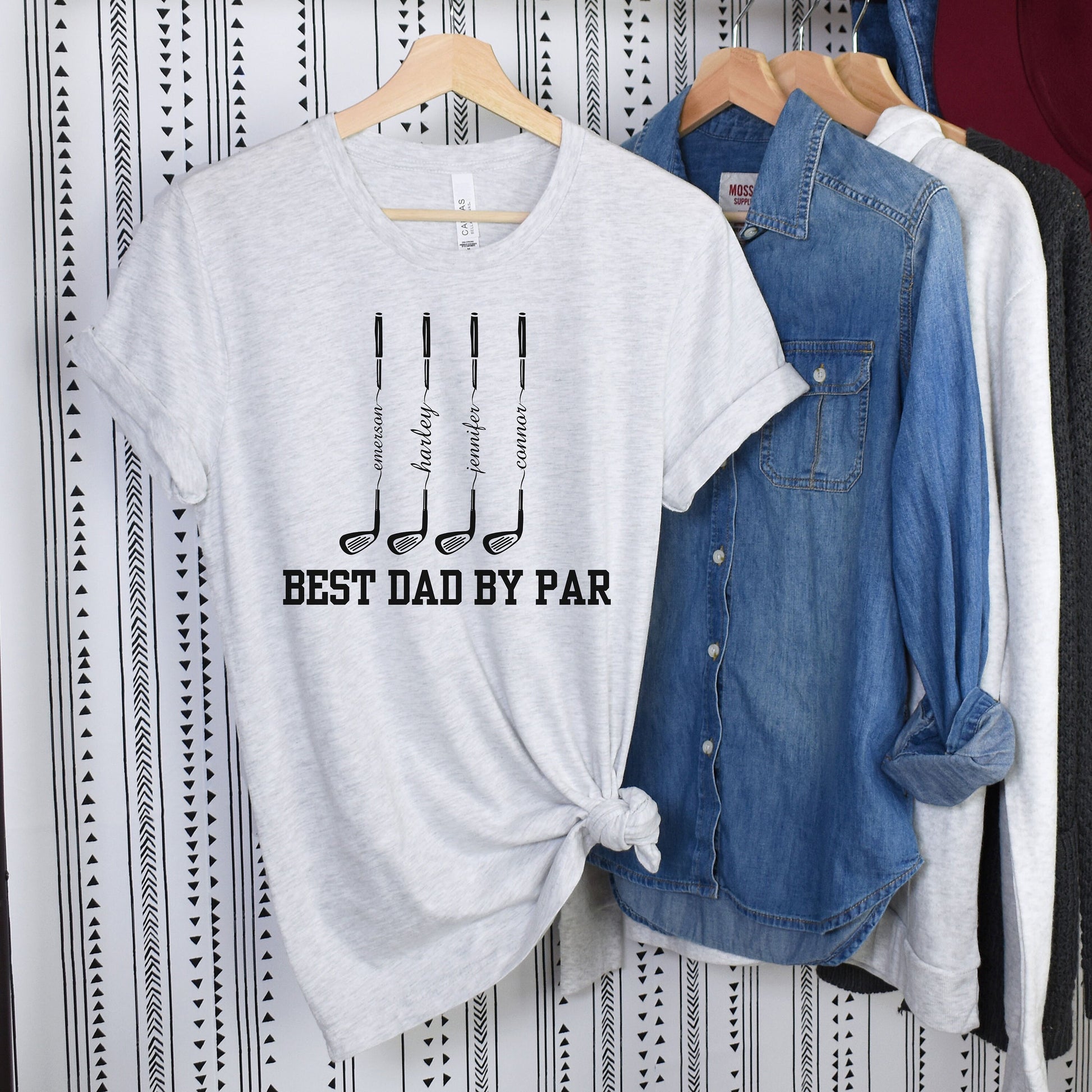 a t - shirt that says best dad by par hanging on a wall